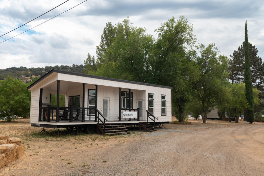 The Ysabella—A 380-sqft Tiny Home with a Wraparound Porch & Fireplace